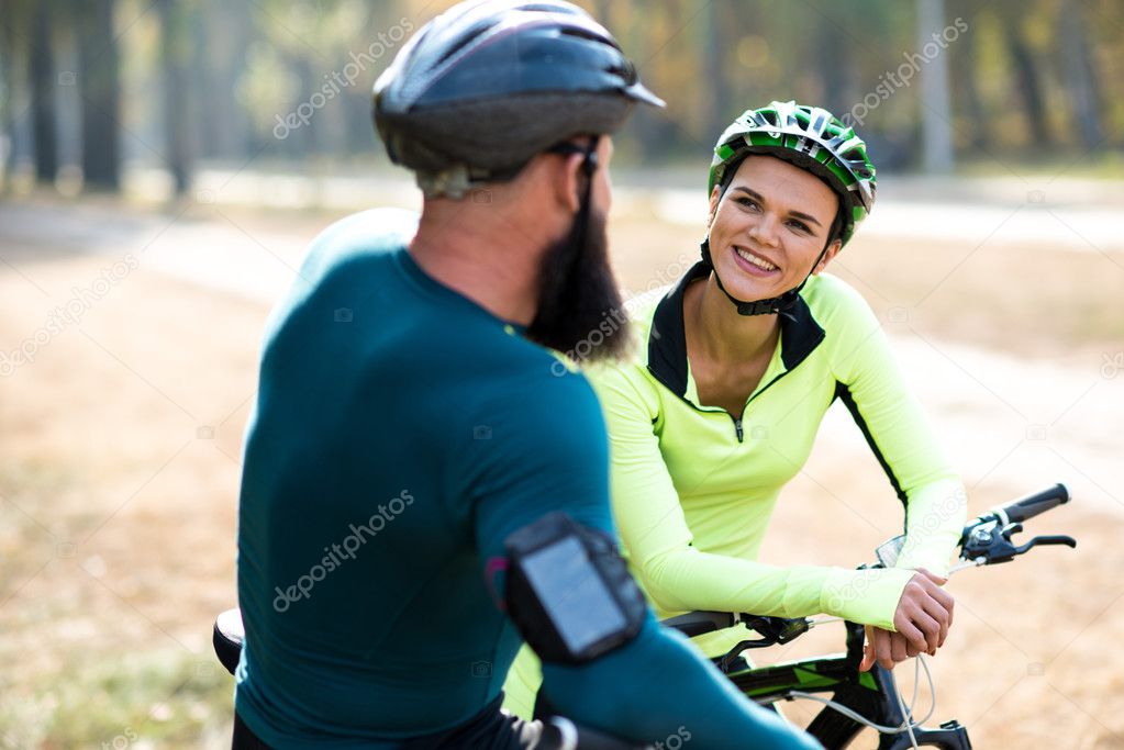 Couple of cyclists in autumn park