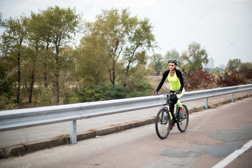 Woman cycling on road