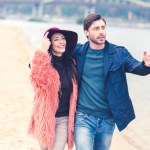 Pareja caminando en la playa de arena