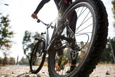 Man in sportswear with bicycle clipart