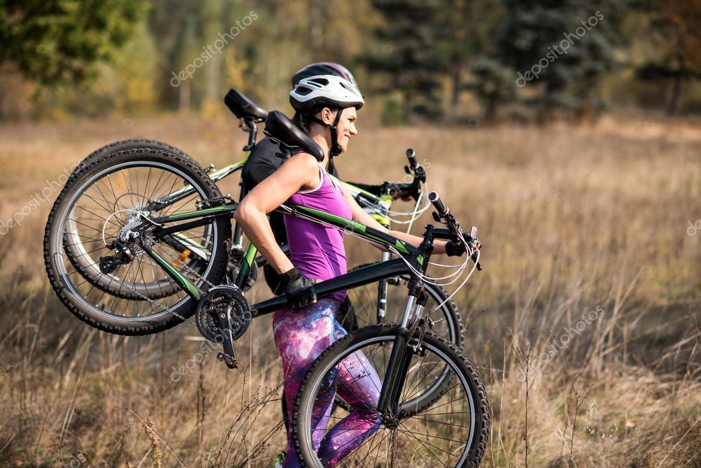 Cyclists carrying bikes — Stock Photo © RomanPashkovsky 127650074