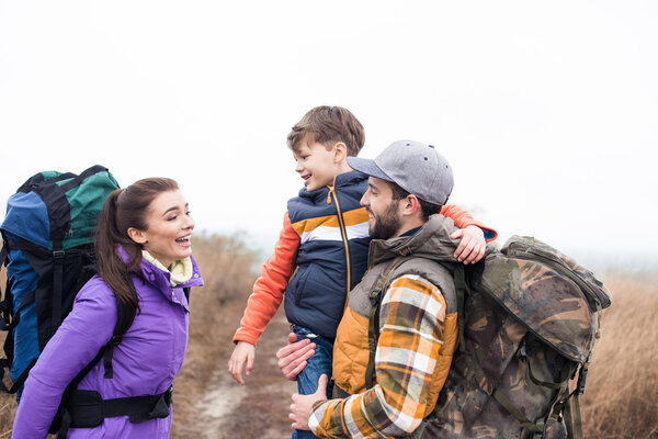 Smiling family with backpacks