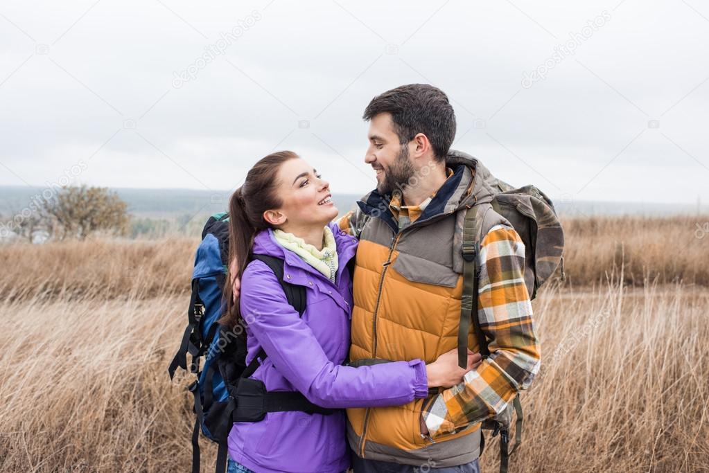 Happy young couple with backpacks