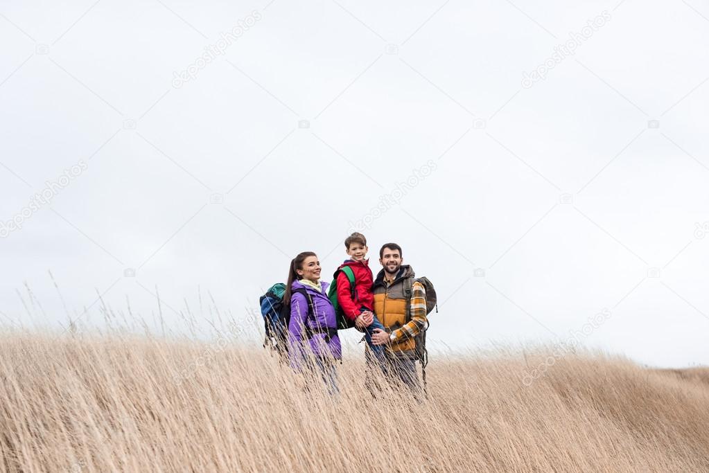 Happy family with backpacks 