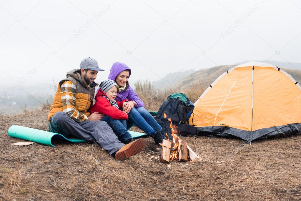 Happy family looking at burning fire