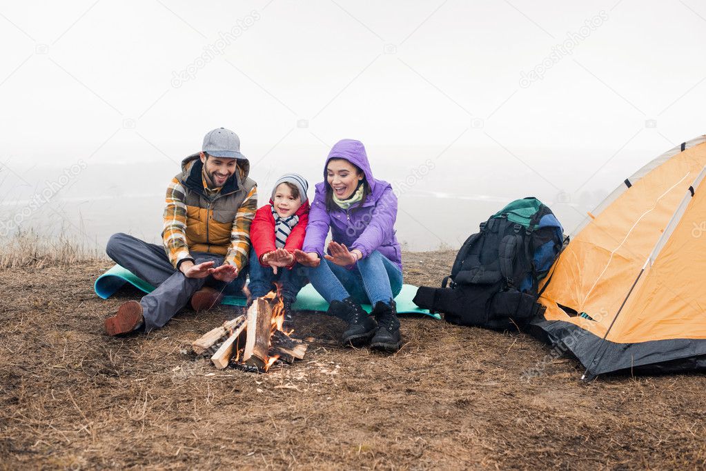 Happy family looking at burning fire
