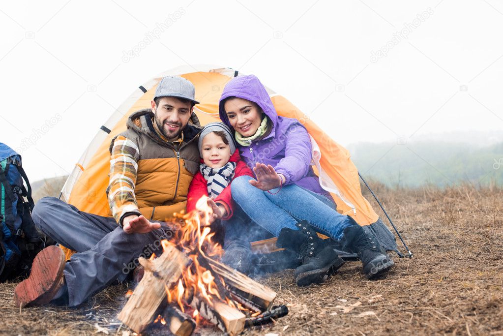 Happy family looking at burning fire