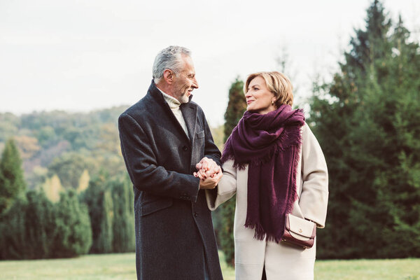 Mature couple walking in autumn park