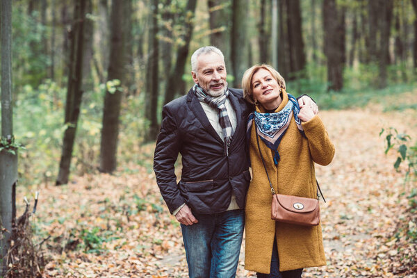 Mature couple walking in park