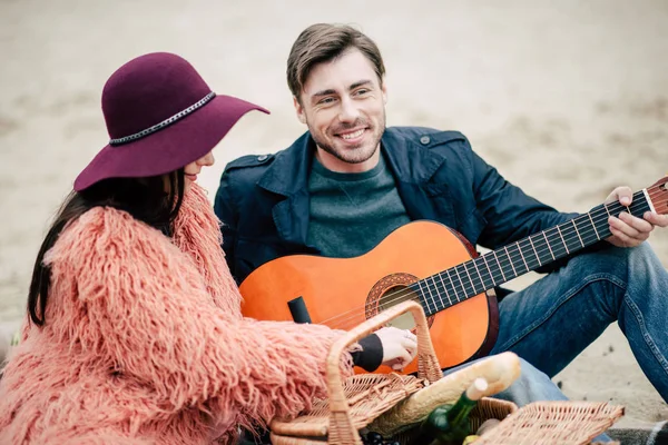 Mężczyzna gra na gitarze na pikniku na świeżym powietrzu — Zdjęcie stockowe