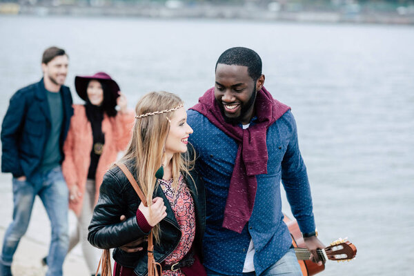Young people having stroll on beach