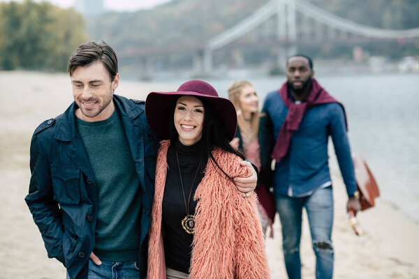 Young people having stroll on beach