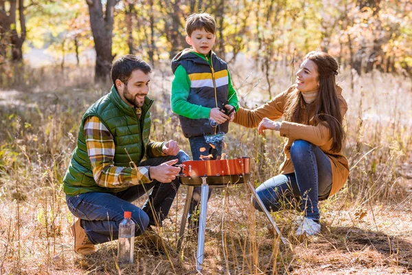Ευτυχισμένη οικογένεια προετοιμασία μπάρμπεκιου στο πάρκο — Φωτογραφία Αρχείου