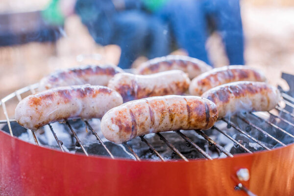 Grilling sausages on barbecue grill 