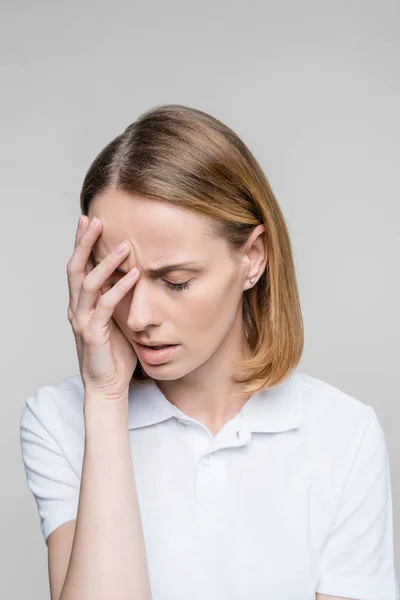 Verärgerte Frau mit Kopfschmerzen Stockbild