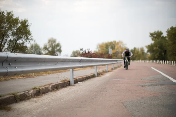 People cycling on roa — Stock Photo