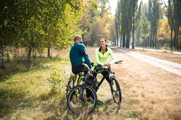 Casal de ciclistas descansando no parque — Fotografia de Stock