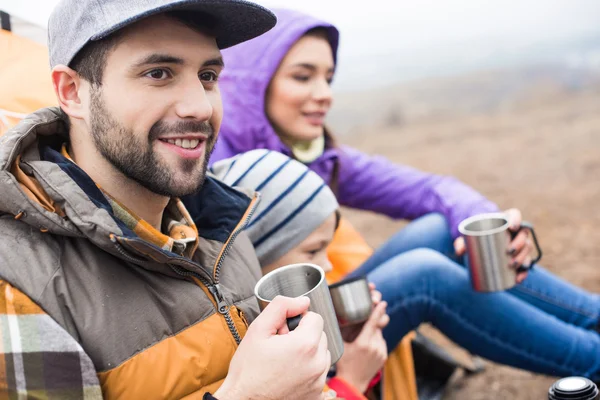 Family drinking tea from metal cups — Stock Photo