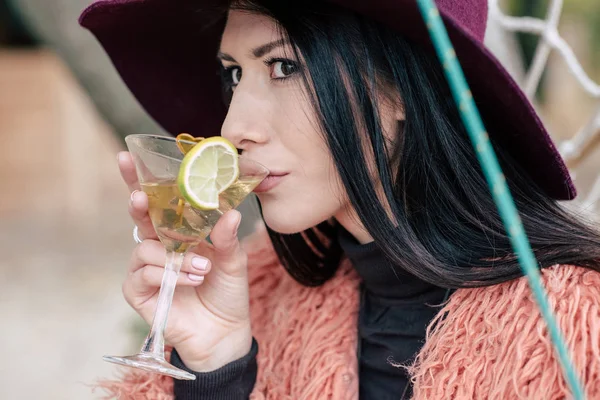 Fashionable young woman drinking cocktail — Stock Photo