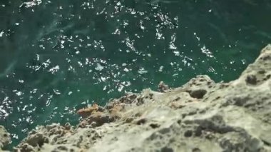 Yaşlı kayalar Körfezi kıyılarında. Rüzgar ve dalgalar taş tarafından bulanık