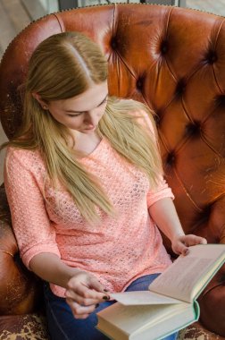 Genç kız kitap ile oturuyor