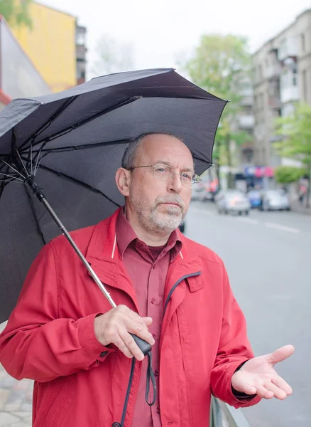 Aged man under the rain