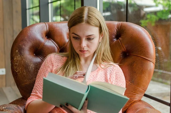 Jovencita está sentada con el libro —  Fotos de Stock