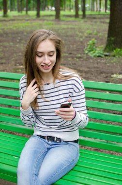 Genç bayan telefonunu kullanıyor.