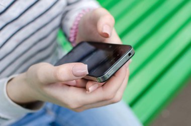 Genç bayan telefonunu kullanıyor.