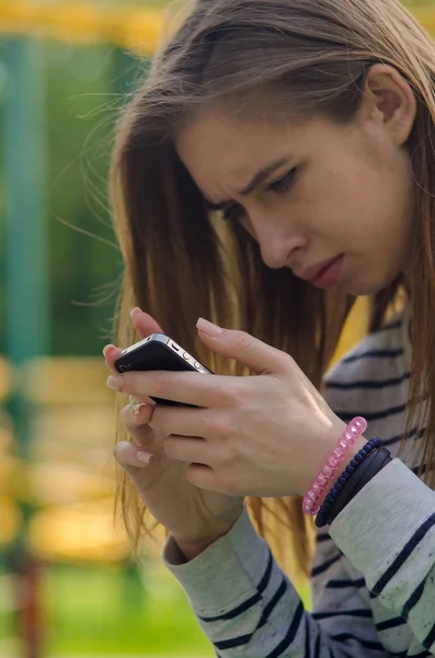 Jovem mulher usando seu telefone — Fotografia de Stock