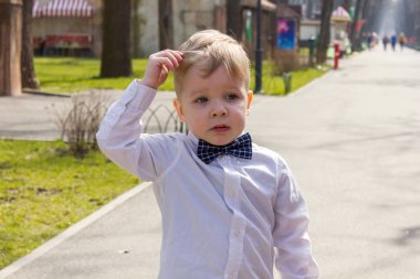 Gömlekli çocuk parkta oynuyor