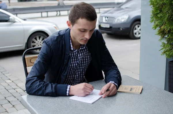 Young man making notes Royalty Free Stock Images