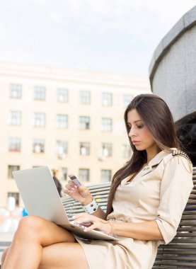 Young woman using credit card