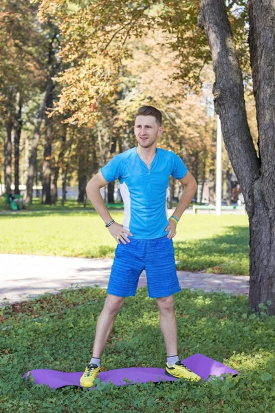 Homme faisant xersises dans le parc dans le tapis — Photo