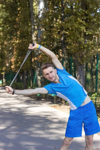 Man making exersises with jumping rope in the park — Stock Photo, Image