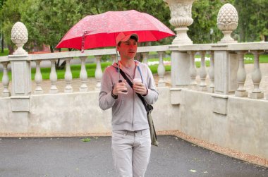 Genç adam şehirde yürüyor.