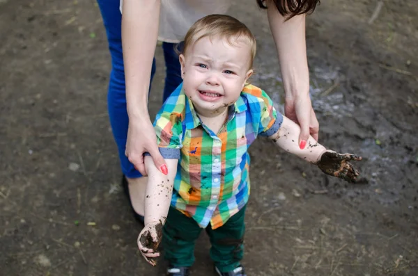 Baby boy with dirty hands in the park Royalty Free Stock Images