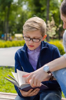 Genç adam genç bir kitap okumak için yardım