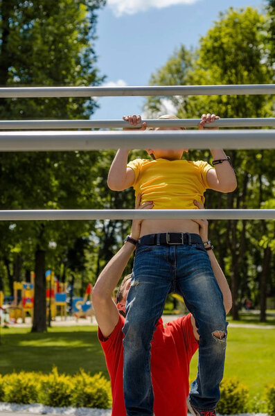 man is helping teenager on the breams