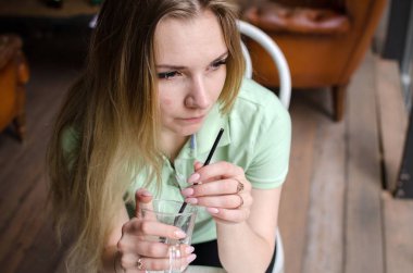 Kadın kafede kahve içiyor.