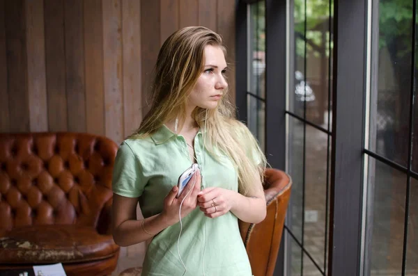 Mujer está escuchando música en los auriculares —  Fotos de Stock