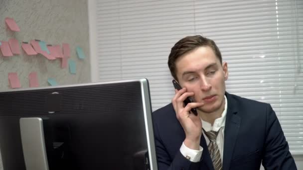 Closeup νεαρός επιχειρηματίας μιλάει για το κινητό τηλέφωνο στο γραφείο — Αρχείο Βίντεο