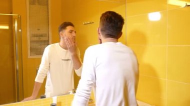 Genç adam banyoda tıraş için hazırlanıyor