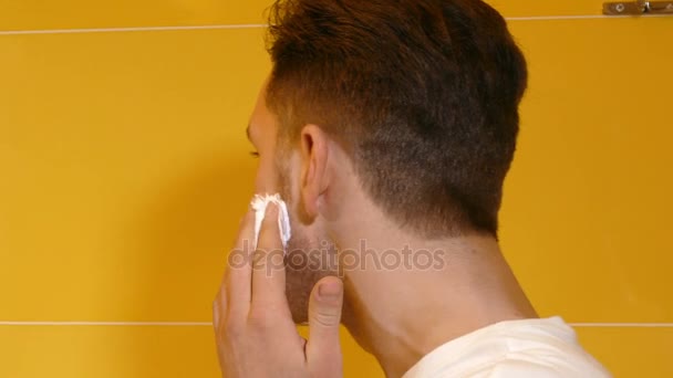 Primer plano de hombre joven afeitándose en el baño — Vídeo de stock