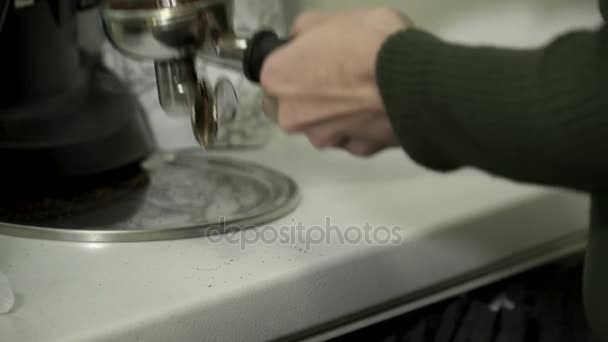 Closeup of young woman pressing ground coffee — Stock Video