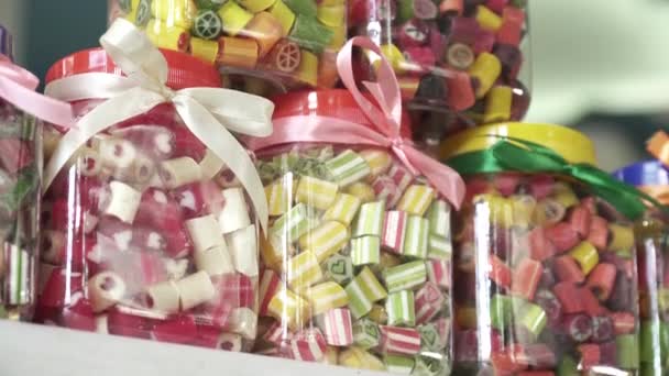 Closeup of different colorful candy in the jar of glass — Stock Video