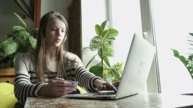 Online alışveriş için kredi kartı kullanan genç kız