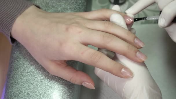 Closeup of polishing nails with the base polish — Stock Video