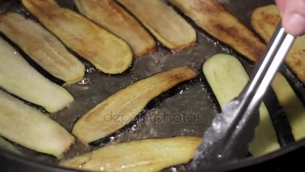Fresh eggplant frying in the light oil — Stock Video