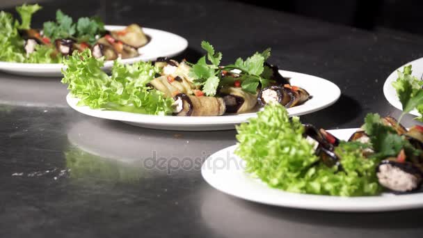 Plates with tasty small eggplant rolls with cheese — Stock Video